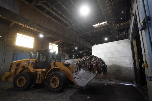 CORRECTS NAME OF FACILITY TO GREENWASTE RENEWABLE ENERGY DIGESTION FACILITY FROM GREENWASTE ZANKER RESOURCE RECOVERY FACILITY - Organic material is demonstrated being loaded into a digester at a GreenWaste Renewable Energy Digestion Facility in San Jose, Calif., Friday, Oct. 27, 2023. A pair of recent reports from the EPA put striking numbers to the problem of food waste: one-third of the food produced in the U.S. is never eaten. California began requiring every jurisdiction to provide organic waste collection services starting in 2022. (AP Photo/Jeff Chiu)