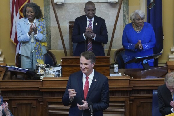 Viriginia Gov. Glenn Youngkin, bottom center, is welcomed as he prepares to delivers his State of the Commonwealth address before a joint session of the Virginia General Assembly as Virginia Lt. Gov. Winsome Earle-Sears, top left, House Speaker Del. Don Scott, D-Portsmouth, and Senate President pro tempore Se. Louis Lucas, D-Portsmouth, top right, listens at the Capitol Wednesday Jan. 10, 2024, in Richmond, Va. (AP Photo/Steve Helber)