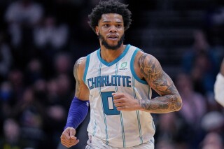 FILE - Charlotte Hornets forward Miles Bridges moves upcourt during the team's NBA basketball game against the Denver Nuggets, March 28, 2022, in Charlotte, N.C. The Charlotte Mecklenburg County Sheriff’s Office says it has an unserved warrant for Bridges for a violation of a domestic violence protective order along with an unserved criminal summons for a domestic protective order violation, misdemeanor child abuse and injury to personal property. The sheriff’s office said the warrant was issued in January and the criminal summons was issued Wednesday, Oct. 11. (AP Photo/Rusty Jones, File)