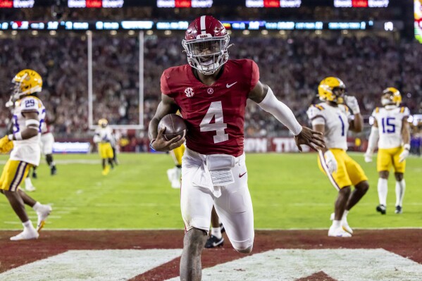 Alabama quarterback Jalen Milroe scores a running touchdown against LSU during the first half of an NCAA college football game, Saturday, Nov. 4, 2023, in Tuscaloosa, Ala. (AP Photo/Vasha Hunt)