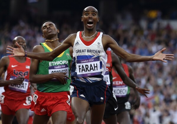 FILE - Britain's Mohamed Farah celebrates as he crosses the finish line to win the men's 5000-meter final during the athletics in the Olympic Stadium at the 2012 Summer Olympics, London, Aug. 11, 2012. (AP Photo/Anja Niedringhaus, File)