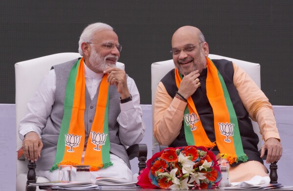 FILE - Indian Prime Minister Narendra Modi, left, and the president of the Bharatiya Janata Party, Amit Shah, in New Delhi, India, April 8, 2019. (AP Photo/Manish Swarup, File)