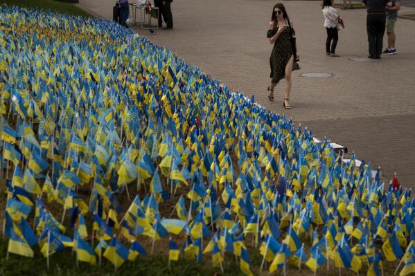 Ukrainian flags to honor soldiers killed fighting Russian troops, are placed in a garden in Kiev's Independence Square, Ukraine, Sunday, Aug. 28, 2022. (AP Photo/Emilio Morenatti)