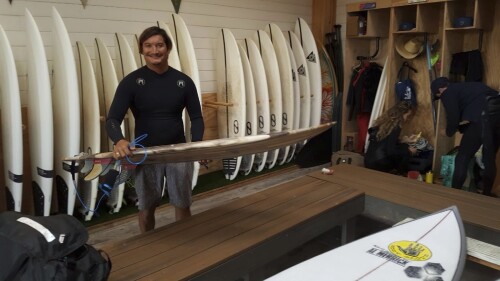 This May 19, 2019 photo provided by Dr. John Jones shows Mikala Jones at Surf Ranch in Lemoore, Calif., holding a surfboard his brother Daniel Jones made using material from the agave plant. Mikala Jones, a Hawaii surfer known for shooting awe-inspiring photos and videos from the inside of barreling waves, has died at the age of 44 after a surfing accident in Indonesia. (Dr. John Jones via AP)