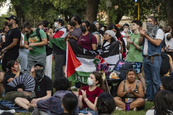 Protesters chant at a pro-Palestinian protest at the University of Texas on Wednesday, April 24, 2024 in Austin, Texas.  Wednesday's protests on the campuses of at least two universities involved clashes with police, while another university closed its campus for the rest of the week.  (Mikala Compton/Austin American-Statesman via AP)