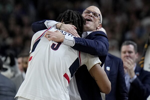 UConn head coach Dan Hurley hugs guard Stephon Castle during the second half of the NCAA college Final Four championship basketball game against Purdue, Monday, April 8, 2024, in Glendale, Ariz. (AP Photo/Brynn Anderson)