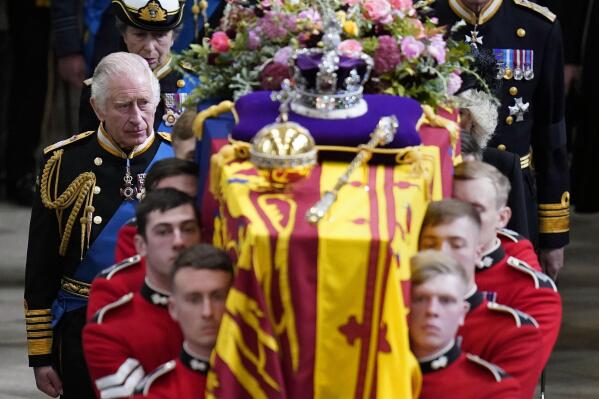 King Charles III and members of the Royal family follow behind the coffin of Queen Elizabeth II, draped in the Royal Standard with the Imperial State Crown and the Sovereign's orb and sceptre, as it is carried out of Westminster Abbey after her State Funeral, in London, Monday, Sept. 19, 2022. (Danny Lawson/Pool Photo via AP)