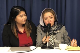 
              Mihrigul Tursun, right, speaks at a event at the National Press Club in Washington, Monday, Nov. 26, 2018. Tursun, a member of China’s Uighur minority is detailing the torture and abuse she suffered at the hands Chinese authorities as part of an escalating clampdown on hundreds of thousands of members of the country's Muslim minorities. Through a translator she said she spent several months in detention in China where she was beaten, tortured with electric shock and given unknown drugs. (AP Photo/Maria Danilova)
            