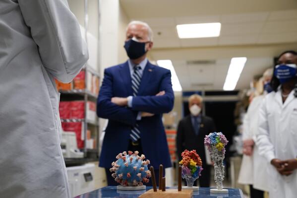 FILE - In this Feb. 11, 2021 file photo, President Joe Biden visits the Viral Pathogenesis Laboratory at the National Institutes of Health (NIH) in Bethesda, Md. This summer’s coronavirus surge has been labeled a “pandemic of the unvaccinated” by government officials from President Joe Biden on down. That sound bite captures the glaring reality that unvaccinated people overwhelmingly account for new cases and serious infections. (AP Photo/Evan Vucci, File)