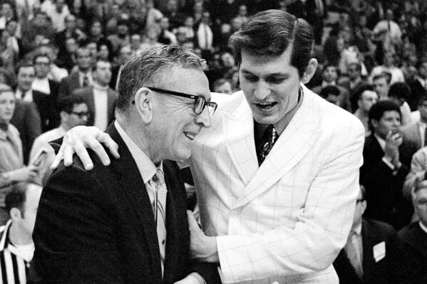 FILE - UCLA Bruins coach John Wooden, left, is congratulated by Jacksonville coach Joe Williams after UCLA beat the Dolphins, 80-69, in the national championship game of the NCAA college basketball tournament on March 21, 1970, in College Park, Md. Williams, who coached Artis Gilmore and tiny Jacksonville University to the 1970 NCAA Tournament championship game against mighty UCLA, died Saturday, March 26, 2022, in Enterprise, Miss., while in hospice care after a lengthy battle with cancer, his son Joe Williams said. He was 88. (AP Photo/File)