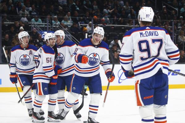 Edmonton Oilers left wing Zach Hyman (18) celebrates with teammates after scoring against the Seattle Kraken during the second period of an NHL hockey game Friday, Dec. 30, 2022, in Seattle. (AP Photo/Lindsey Wasson)