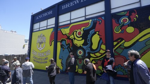 People wait in line outside Anchor Public Taps in San Francisco, Thursday, July 13, 2023. San Francisco's 127-year-old Anchor Brewing Co. will shut down and liquidate after years of declining sales, citing tough economic conditions. (AP Photo/Jeff Chiu)