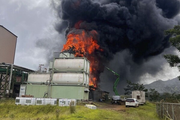 In this image provided by KITV4, flames erupt at the Biomass Power Plant on Hawaii's Kauai Island, Friday, March 8, 2024. (Shantelle Shimogawa/Courtesy of KITV4 via AP)