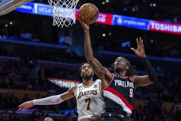 Portland Trail Blazers forward Jerami Grant, right, shoots against Los Angeles Lakers forward Troy Brown Jr. during the second half of an NBA basketball game Sunday, Oct. 23, 2022, in Los Angeles. (AP Photo/Alex Gallardo)