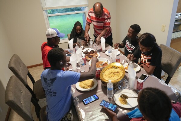 Mauritanians gather for a traditional meal, Friday, July 21, 2023, in Cincinnati. (AP Photo/Darron Cummings)