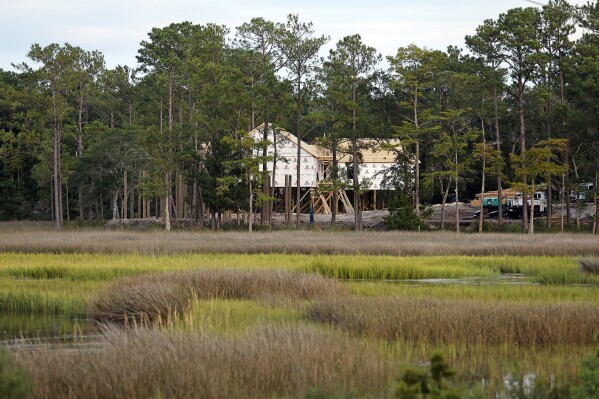 Homes are visible under construction near wetlands in Oak Island, N.C., Tuesday, Aug. 29, 2023. The Biden Administration weakened protections for wetlands on Tuesday, a win for developers and agricultural groups in some states. (AP Photo/Karl B DeBlaker)