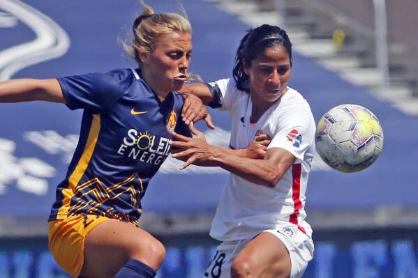 FILE - Utah Royals FC defender Madeline Nolf, left, battles with OL Reign midfielder Shirley Cruz, right, during the first half of an NWSL Challenge Cup soccer match at Zions Bank Stadium, Wednesday, July 8, 2020, in Herriman, Utah. The Royals are returning to Utah and the National Women's Soccer League. The NWSL and Major League Soccer's Real Salt Lake announced the second iteration of the Utah Royals on Saturday, March 11, 2023.. The Royals were part of the NWSL for three seasons from 2018 to 2020. (AP Photo/Rick Bowmer, File)