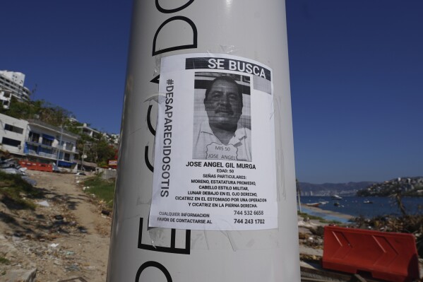A missing persons sign with the hashtag "otis disappeared" covers a post in Acapulco, Mexico, Sunday, Nov. 12, 2023. It was 12:20 a.m. on Oct. 25. when Hurricane Otis made landfall in this Pacific port city as a Category 5 hurricane, leaving 48 dead, mostly by drowning, and 31 missing, according to official figures. Sailors, fishermen and relatives of crew members believe that there may be more missing because sailors often go to take care of their yachts when a storm approaches. (AP Photo/Marco Ugarte)