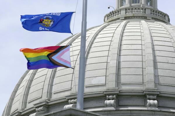 FILE - In this Wednesday, June 1, 2022, photo, a Rainbow Pride flag is raised at the Capitol in Madison, Wis. A Wisconsin school board has voted in favor of a policy that prohibits teachers and staff from displaying gay pride flags and other items that district officials consider political in nature. (Mark Hoffman/Milwaukee Journal-Sentinel via AP, File)