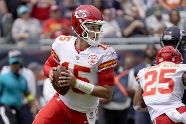 Kansas City Chiefs quarterback Patrick Mahomes rolls out to pass during the first half of an NFL preseason football game against the Chicago Bears Saturday, Aug. 13, 2022, in Chicago. (AP Photo/David Banks)