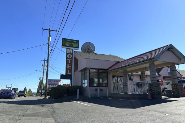 Cars pass by the Emerald Motel and Seattle Inn on Aurora Avenue North in Seattle, on Thursday, Aug. 3, 2023. Police recently declared the establishments to be chronic nuisances due to rampant prostitution and other criminal activity, a step that requires the owners to demonstrate how they will prevent their properties from being used for criminal behavior. The recent harrowing escape of a woman who was abducted after engaging in prostitution on Seattle has helped focus attention on the consequences of tolerating an open sex trade along the thoroughfare. (AP Photo/Gene Johnson)