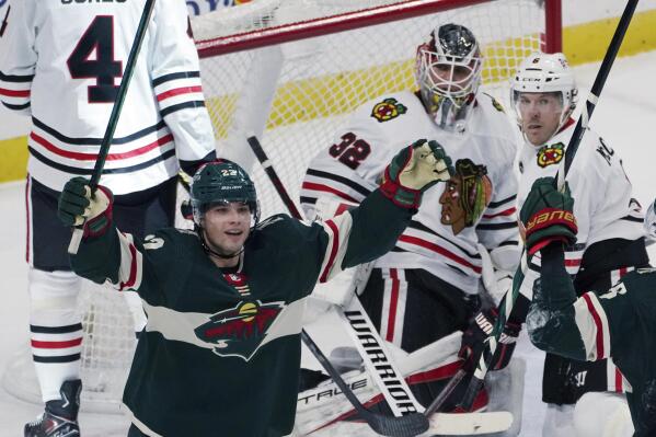 Minnesota Wild's Kevin Fiala, left, celebrates his goal against Chicago Blackhawks goalie Kevin Lankinen (32) during the third period of an NHL hockey game Saturday, Jan. 22, 2022, in St. Paul, Minn. The Wild won 4-3 in overtime. (AP Photo/Jim Mone)