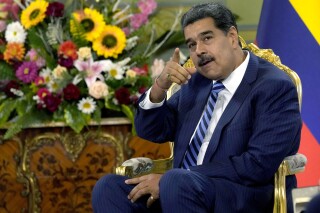 FILE -Venezuela's President Nicolas Maduro points while meeting Colombia's new ambassador to Venezuela, at the Miraflores Presidential Palace in Caracas, Venezuela, Wednesday, Aug. 16, 2023. United Nations human rights experts are criticizing Venezuela’s government for stepping up efforts to curtail democratic freedoms with use of threats, surveillance and harassment as President Nicolás Maduro faces reelection next year. (AP Photo/Ariana Cubillos, File)