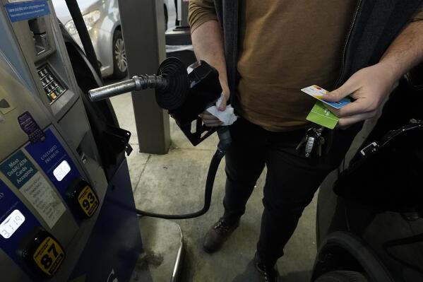 FILE - A customer prepares to pump gasoline into his car at a Sam's Club fuel island in Gulfport, Miss., Feb. 19, 2022. The U.S. economy shrank last quarter for the first time since the pandemic recession struck two years ago, Thursday, April 28, 2022, contracting at a 1.4% annual rate, but consumers and businesses kept spending in a sign of underlying resilience.  (AP Photo/Rogelio V. Solis)