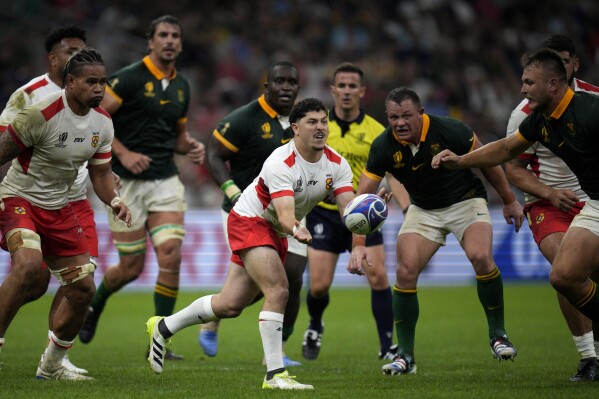 Tonga's Patrick Pellegrini passes the ball during the Rugby World Cup Pool B match between South Africa and Tonga at the Marseille's Stade Velodrome, in Marseille, France Sunday, Oct. 1, 2023. (AP Photo/Daniel Cole)