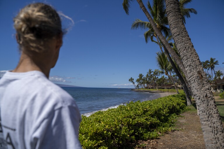 Daniel Skousen looks at the beach near his home on Friday, Nov. 3, 2023, in Lahaina, Hawaii. Skousen used to swim in the ocean daily, but since August's wildfire, he has only been back in the water once. (AP Photo/Mengshin Lin)