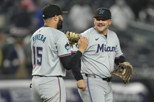 Miami Marlins' Jake Burger, right, celebrates with Emmanuel Rivera after the baseball game against the New York Yankees at Yankee Stadium, Wednesday, April 10, 2024, in New York. The Marlins defeated the Yankees 5-2. (AP Photo/Seth Wenig)