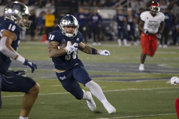 Nevada running back Toa Taua (35) carries against UNLV during the first half of an NCAA college football game in Reno, Nev., Friday, Oct. 29, 2021. (AP Photo/Tom R. Smedes)