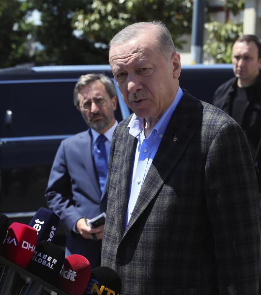 In this photo made available by the Turkish Presidency, Turkish President Recep Tayyip Erdogan speaks to the media after Friday prayers, in Istanbul, Turkey, Friday, May 13, 2022. Erdogan said Friday that his country is "not favorable" toward Finland and Sweden joining NATO, indicating that Turkey could use its status as a member of the Western military alliance to veto moves to admit the two countries. (Turkish Presidency via AP)