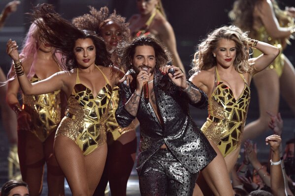 FILE - Maluma, center, performs at the MTV Video Music Awards in New York on Aug. 20, 2018. Maluma will perform at the 2020 MTV Video Music Awards on Aug. 30. (Photo by Chris Pizzello/Invision/AP, File)