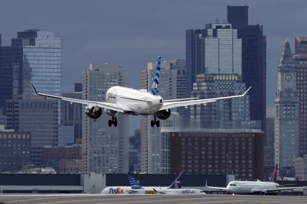 FILE - A plane lands at Logan International Airport, Thursday, Jan. 26, 2023, in Boston. The Biden administration is out with new guidelines Tuesday, April 30, 2024, for tax credits for producers of sustainable aviation fuel. (AP Photo/Michael Dwyer, File)