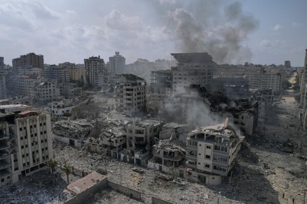 A view of the rubble of buildings hit by an Israeli airstrike, in Gaza City, Tuesday, Oct. 10, 2023. Israel has launched intense airstrikes in Gaza after the territory's militant rulers carried out an unprecedented attack on Israel Saturday, killing over 900 people and taking captives. Hundreds of Palestinians have been killed in the airstrikes. (AP Photo/Hatem Moussa)