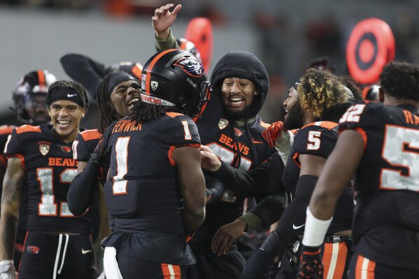 Oregon State running back Deshaun Fenwick (1) celebrates with teammates after scoring a touchdown against Stanford during the second half of an NCAA college football game Saturday, Nov. 11, 2023, in Corvallis, Ore. Oregon State won 62-17. (AP Photo/Amanda Loman)