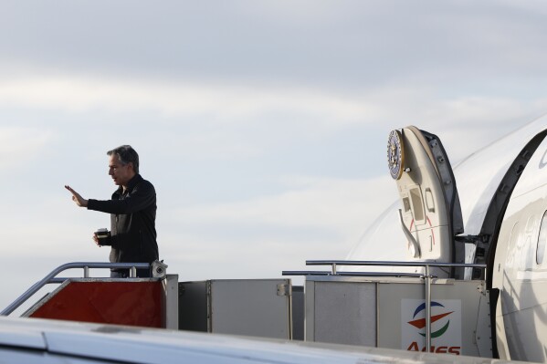 U.S. Secretary of State Antony Blinken waves as he departs Philippines en route to Saudi Arabia, at Ninoy Aquino International Airport in Pasay City, Manila, Philippines, Wednesday, March 20, 2024. (Evelyn Hockstein/Pool Photo via AP)