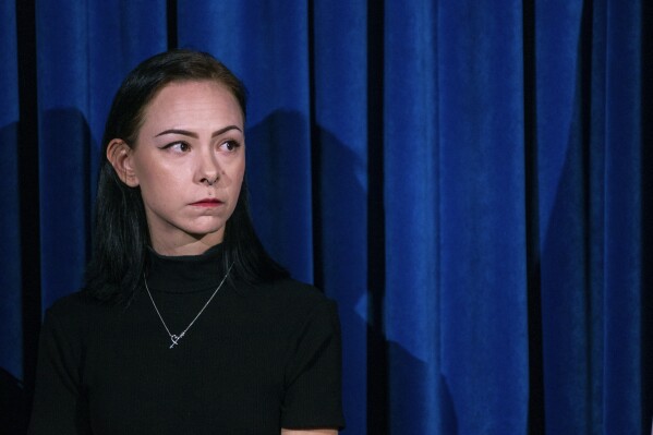 Taylor Probst, a family member of Andreas Rene Probst, a cyclist who was intentionally struck in a series of hit-and-run crashes, waits to speak at a news conference on Tuesday, Sept. 19, 2023, in Las Vegas. Las Vegas police on Tuesday announced a second teenager has been arrested in a series of hit-and-run crashes, including the death of a former California police chief who was riding a bicycle last month. (AP Photo/Ty ONeil)