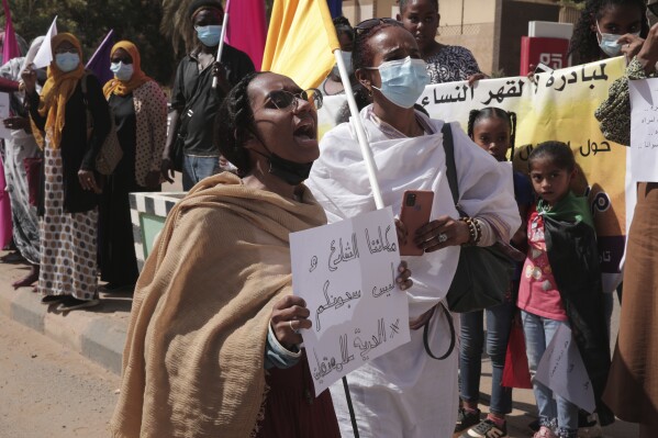 FILE - Women chant slogans protesting violence against women and demanding the release of all detainees before the U.N. rights office in Khartoum, Sudan, Feb. 2, 2022. Sudan's powerful paramilitary has been singled out by a leading rights group and 30 United Nations experts with accusations of rape and sexual violence against women in separate statements, as the country enters its fourth month of conflict. The New York-based Human Rights Watch said Thursday, AUg. 17, 2023, the Rapid Support Forces paramilitary apparently targeted women and girls in the western Darfur region of non-Arab ethnicity as well as activists recording human rights abuses during its fighting with the country's armed forces. (AP Photo/Marwan Ali, File)