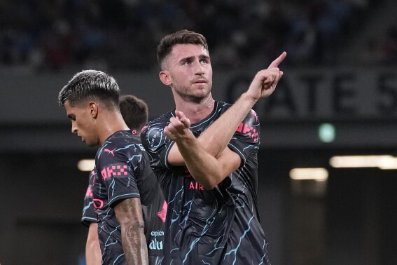 Manchester City's Aymeric Laporte, center, celebrates with teammates after scoring a goal against Bayern during a friendly soccer match at the National Stadium in Tokyo, Japan, Wednesday, July 26, 2023.(AP Photo/Shuji Kajiyama)