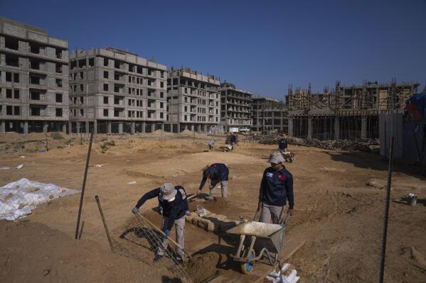 A Palestinian excavation team works in a newly discovered Roman era cemetery in the Gaza Strip, Sunday, Dec. 11, 2022. Hamas authorities in Gaza announced the discovery of over 60 tombs in the ancient burial site. Work crews have been excavating the site since it was discovered last January during preparations for an Egyptian-funded housing project. (AP Photo/Fatima Shbair)
