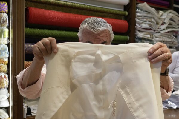 Italian tailor Raniero Mancinelli, who on his own initiative is making outfits for a possible future Pope, shows a pontiff's unfinished garment as he is interviewed by the Associated Press inside his shop in Rome, Wednesday, April 30, 2025. (AP Photo/Gregorio Borgia)