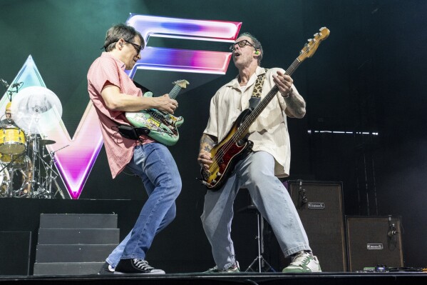 Rivers Cuomo, left, and Scott Shriner of Weezer perform during the first weekend of the Coachella Valley Music and Arts Festival at the Empire Polo Club on Saturday, April 12, 2025, in Indio, Calif. (Photo by Amy Harris/Invision/AP)