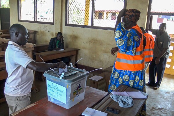 In this image taken from video, a man casts his vote in Bangui, Central African Republic, Sunday July 30, 2023. The Central African Republic went to the polls on Sunday in a highly anticipated vote on a new constitution, which would remove presidential term limits. (AP Photo)