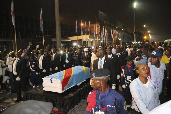 The coffin carrying the remains of longtime Congolese opposition leader Etienne Tshisekedi arrives at Kinshasa airport Thursday, May 30, 2019. The body of Tshisekedi, father of the current Congolese President Felix Tshisekedi, died in Brussels in February 2017, was returned to home soil Thursday night for burial more than two years after his death, after a political standoff ended. (AP Photo/John Bompengo)