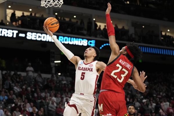 Alabama guard Jahvon Quinerly (5) shoots against Maryland guard Ian Martinez (23) during the second half of a second-round college basketball game in the men's NCAA Tournament in Birmingham, Ala., Saturday, March 18, 2023. (AP Photo/Rogelio V. Solis)