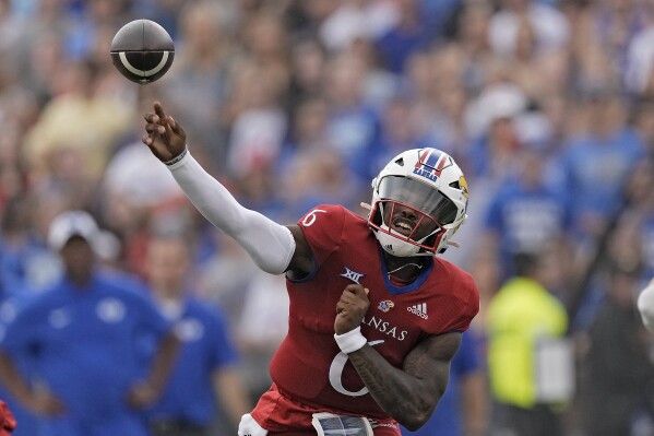 Kansas quarterback Jalon Daniels passes the ball during the first half of an NCAA college football game against BYU Saturday, Sept. 23, 2023, in Lawrence, Kan. (AP Photo/Charlie Riedel)