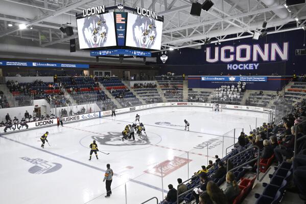 The puck is dropped at the start of the second period of an NCAA college hockey game between UConn and Merrimack, Jan. 13, 2023, at the Toscano Family Ice Forum in Storrs, Conn. (AP Photo/Jessica Hill)