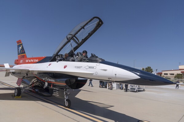 Air Force Secretary Frank Kendall sits in the front cockpit of an X-62A VISTA aircraft at Edwards Air Force Base, Calif., on Thursday, May 2, 2024. The flight on the Artificial Intelligence-controlled modified F-16, is serving as a public statement of confidence in the future role of AI in air combat. The military is planning to use the technology to operate an unmanned fleet of 1,000 aircraft. Arms control experts and humanitarian groups are concerned that AI might one day be able to take lives autonomously and are seeking greater restrictions on its use. (AP Photo/Damian Dovarganes)